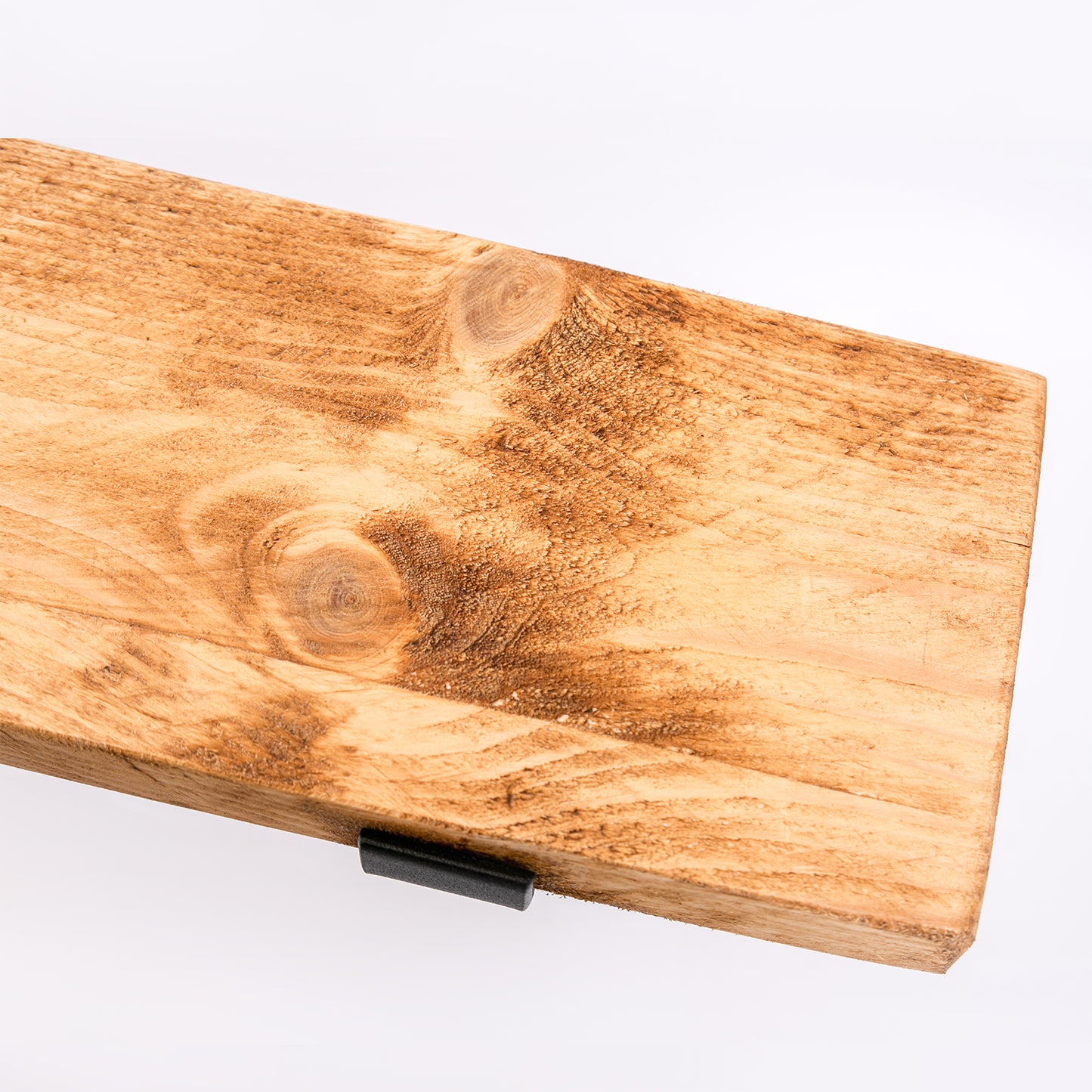 Handmade wooden shelf with black steel brackets. Close up of woodwork