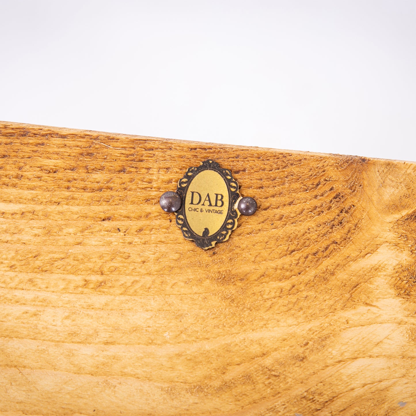 Handmade wooden shelf with black steel brackets. Close up of badge