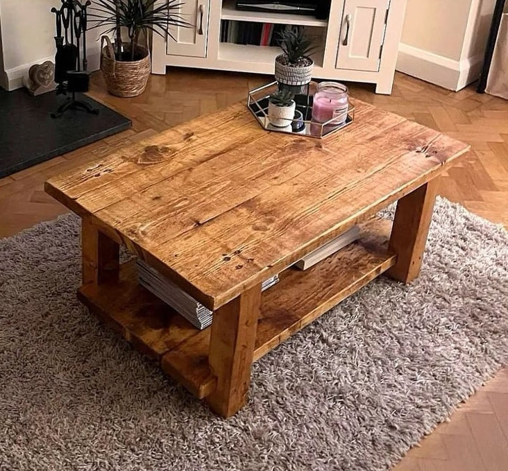 Handmade coffee table, built with chunky wood and a waxed finish. A flat top surface and a low shelf underneath for storage