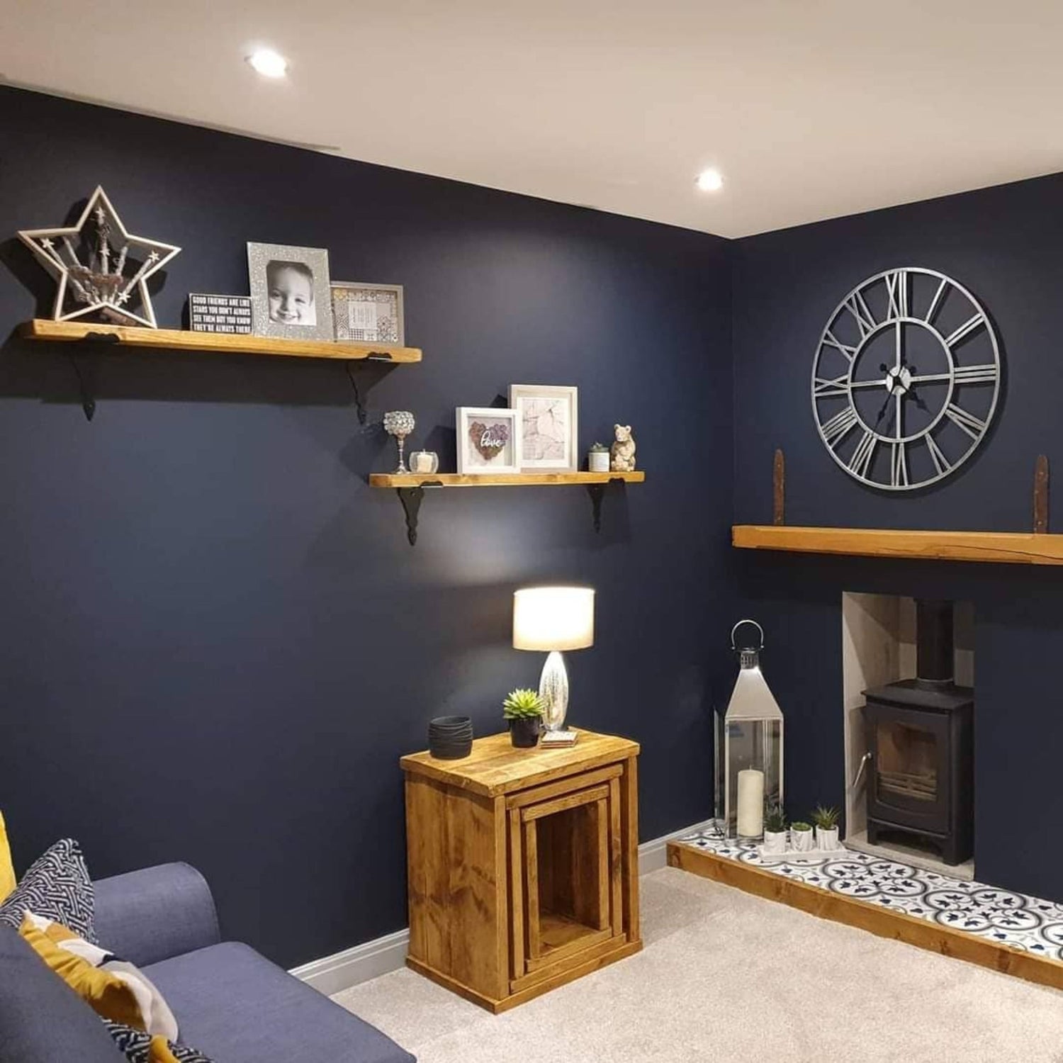 Bespoke wooden interior by DAB using rustic wooden fireplace trim and mantle with matching table nest & shelving