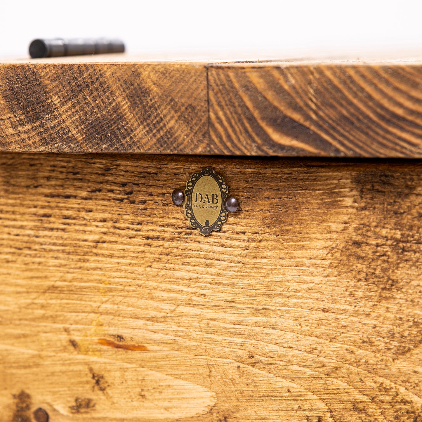 Dining Table Seat & Wooden Blanket Box. Close up of badge