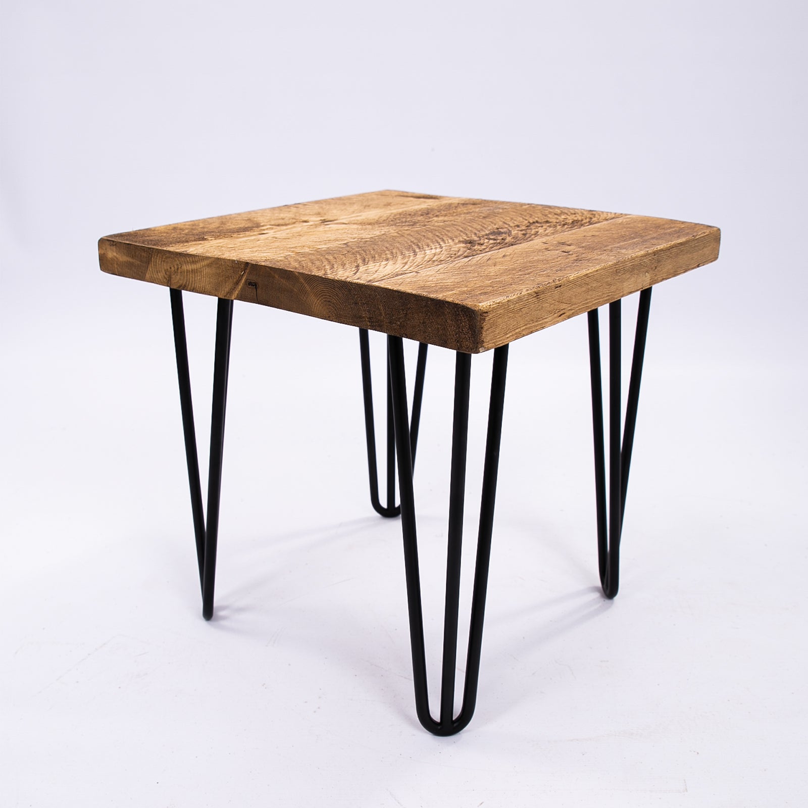 Hairpin legged wooden stool. Corner view