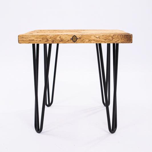 Steel hairpin legs on wooden stool. Front view