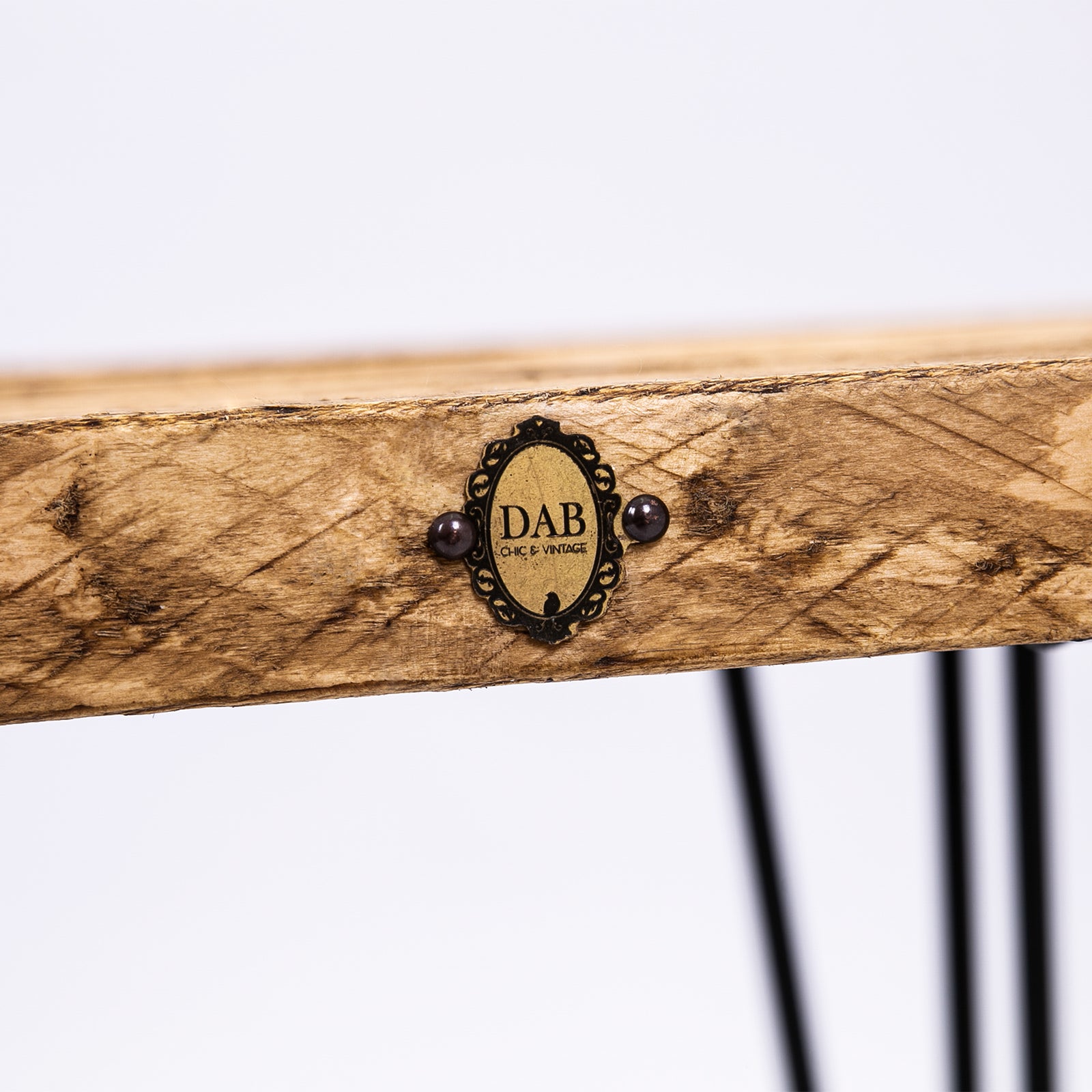 Hairpin wooden stool. Close up of badge