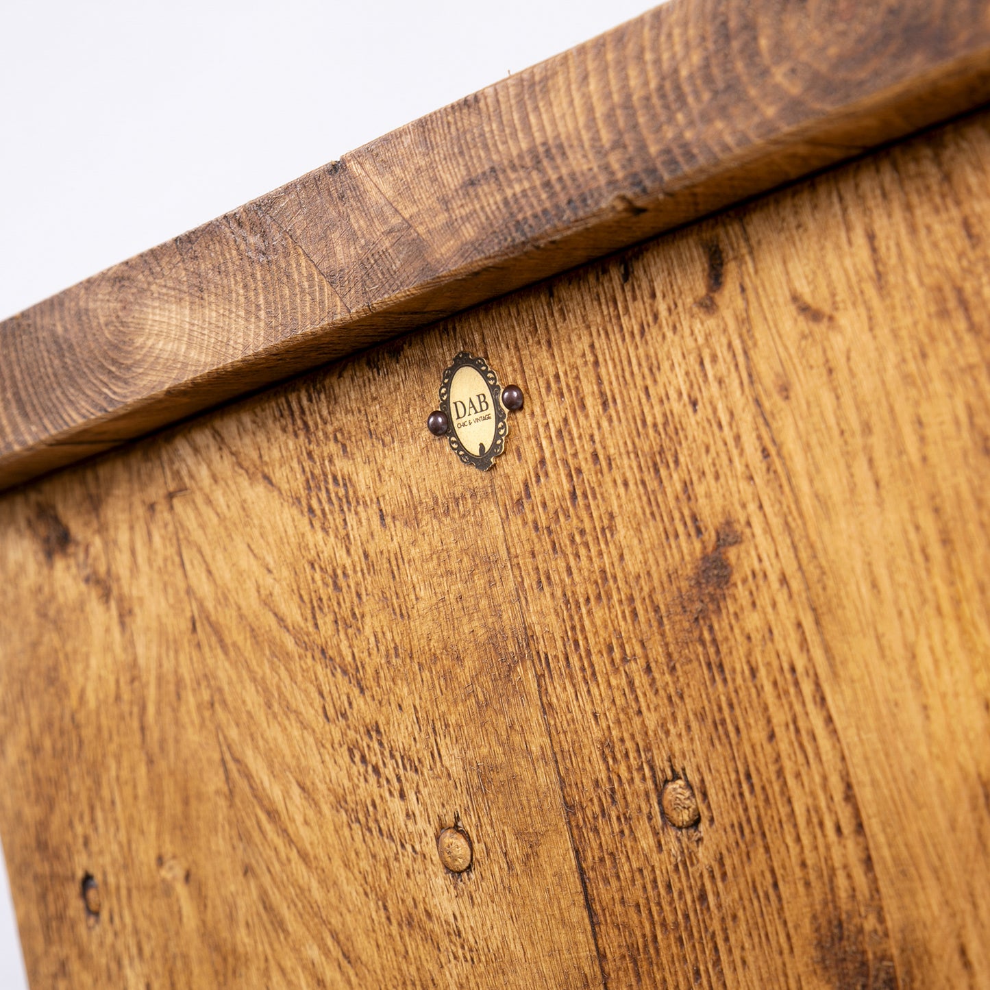 Handmade rustic TV stand with black metal legs. Close up of badge