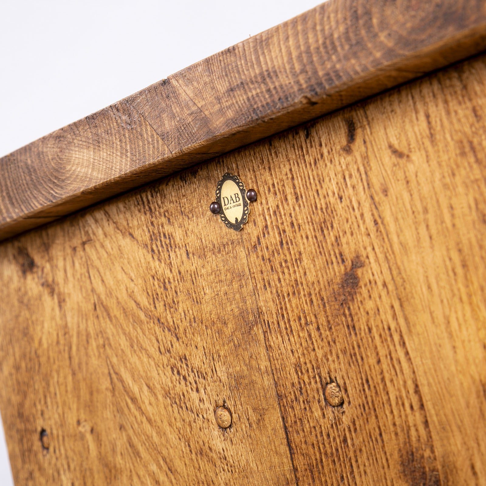 Handmade rustic TV stand with black metal legs. Close up of badge