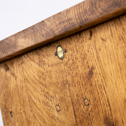 Handmade rustic TV stand with black metal legs. Close up of badge