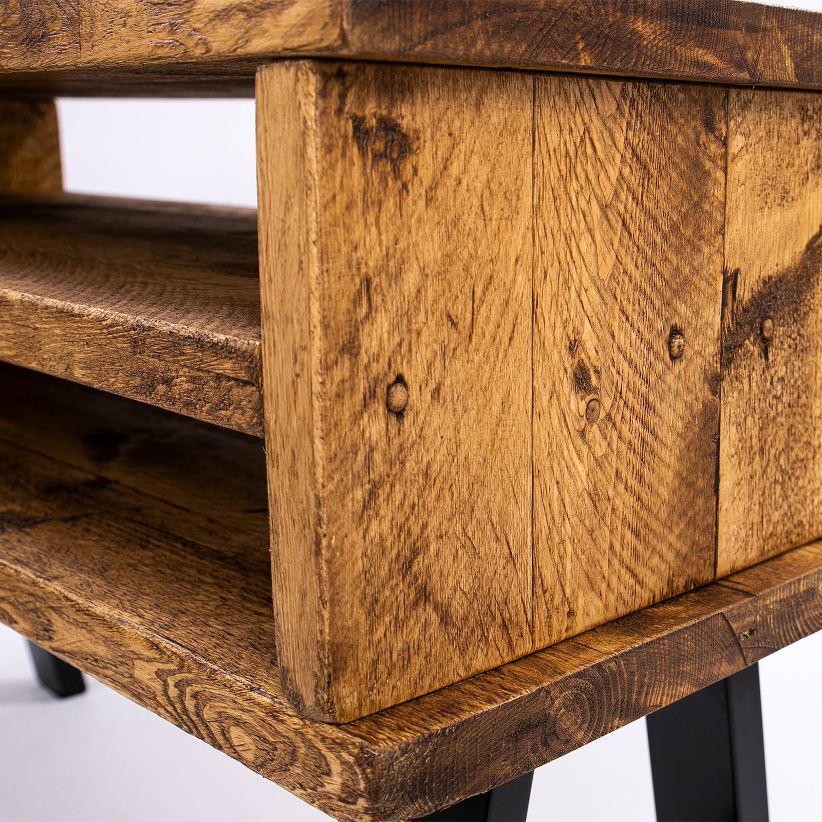 Handmade rustic TV stand with black metal legs. Side angle close up view