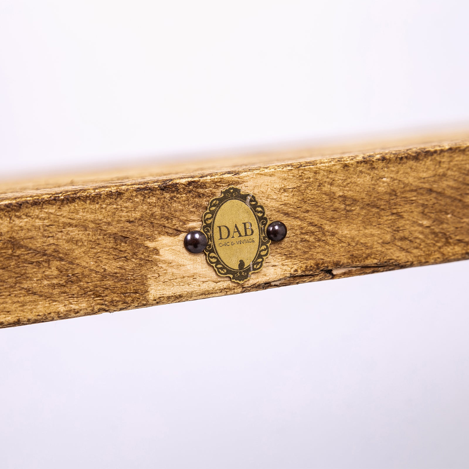 Handmade wooden table with black steel legs. Close up of badge