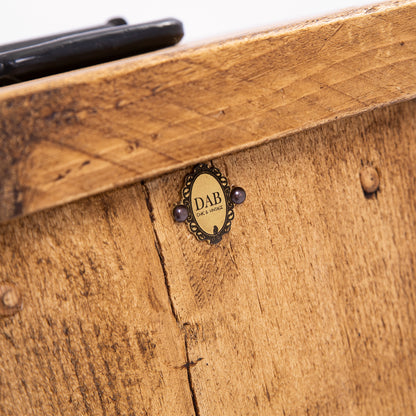 Close up of top of DAB heavy duty door stopper. Showing badge, wood grain and black steel handle