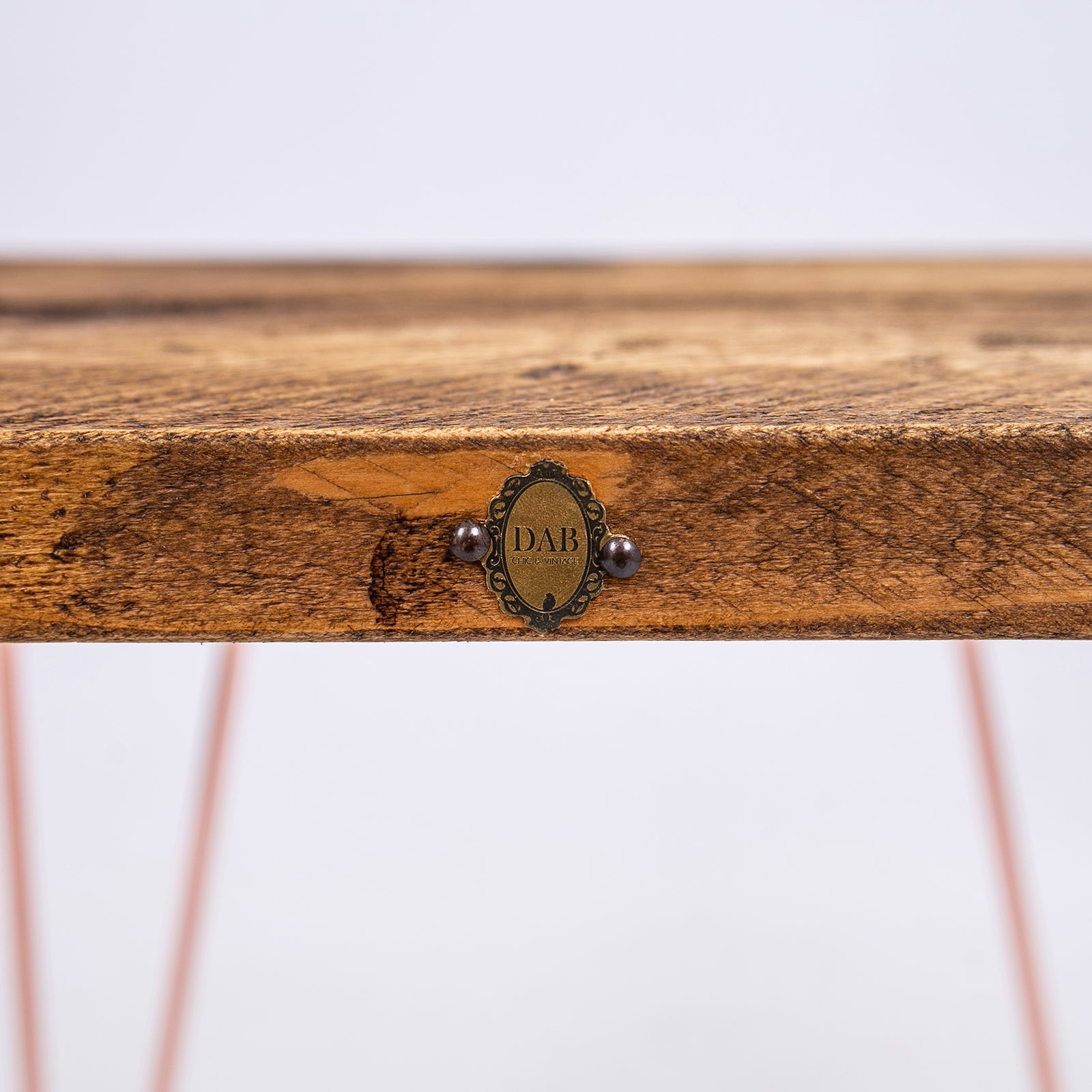 Steel Hairpin Bar Stool with rose gold hairpin legs. Close up of badge